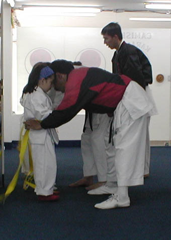Natasha receiving her yellow belt in Karate