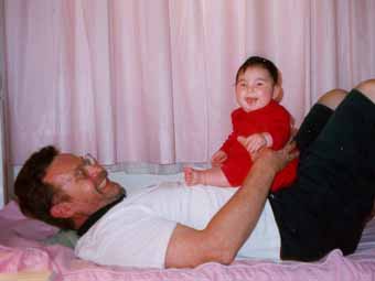 Natasha and her grandfather playing in the bed on Tenerife