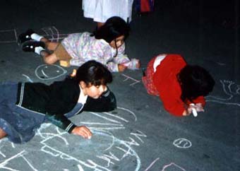 Anita, Fernanda, and Natasha drawing on the street